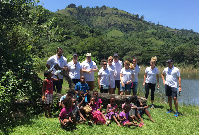 Pearly Grey staff with children from Yami Children’s Village